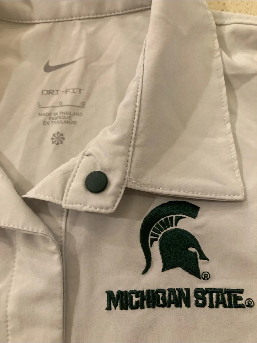 Nike White Short-Sleeve Michigan State Polo with Green Logo